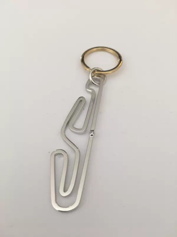 Motorsport keychain in 18kt gold with Tazio Nuvolari circuit silhouette and diamond at the start