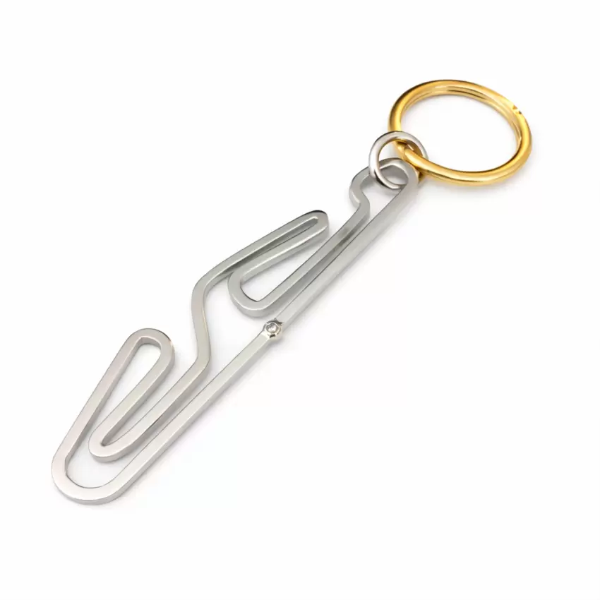 Motorsport keychain in 18kt gold with Tazio Nuvolari circuit silhouette and diamond at the start  