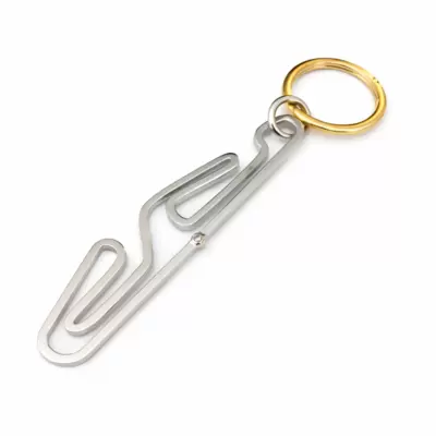Motorsport keychain in 18kt gold with Tazio Nuvolari circuit silhouette and diamond at the start 